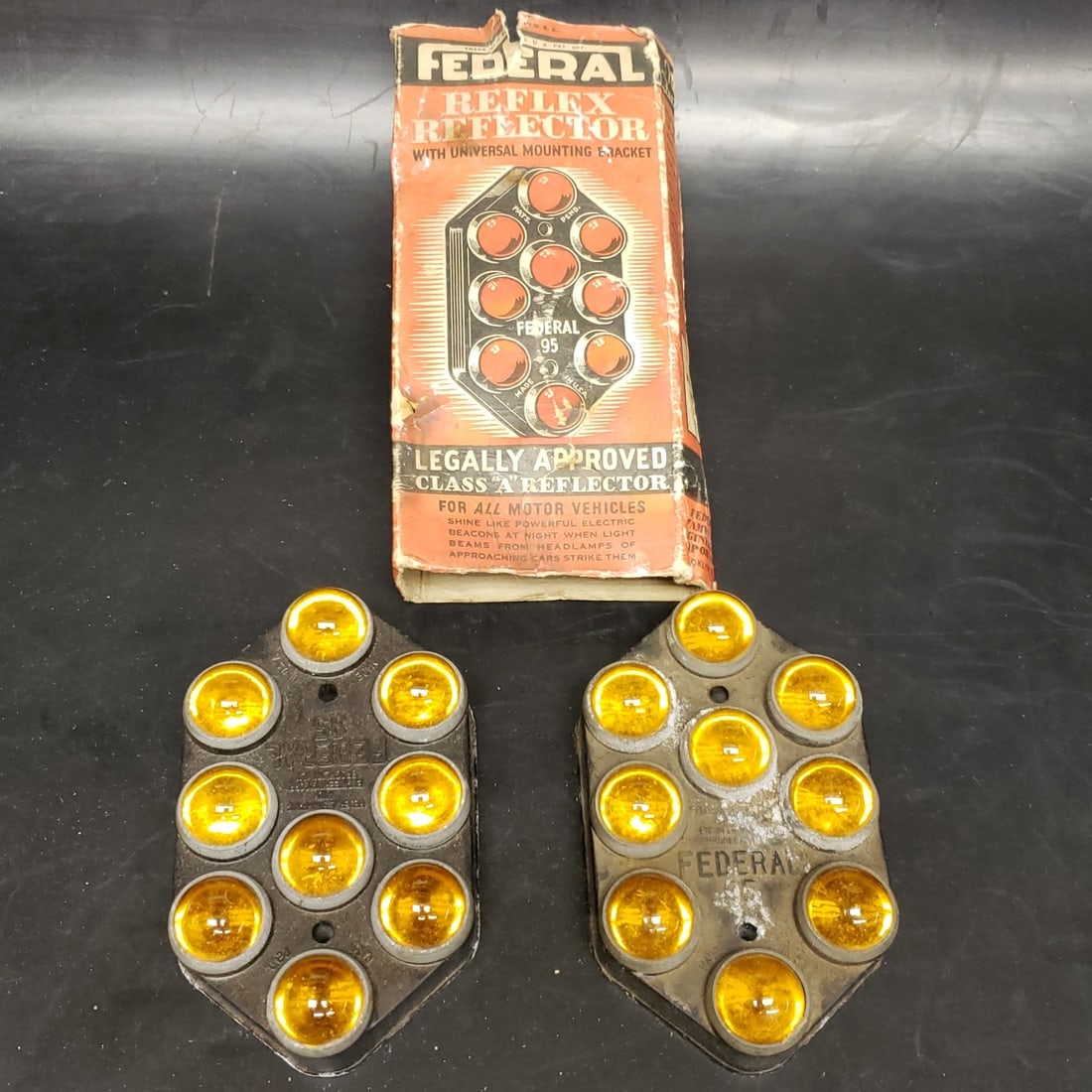 Federal Reflex Reflector lot: "Fresh to market from a lifetime collector. A nice selection of vintage tin and pressed steel along with die cast model and car related ephemera. All measurements are approximate.
