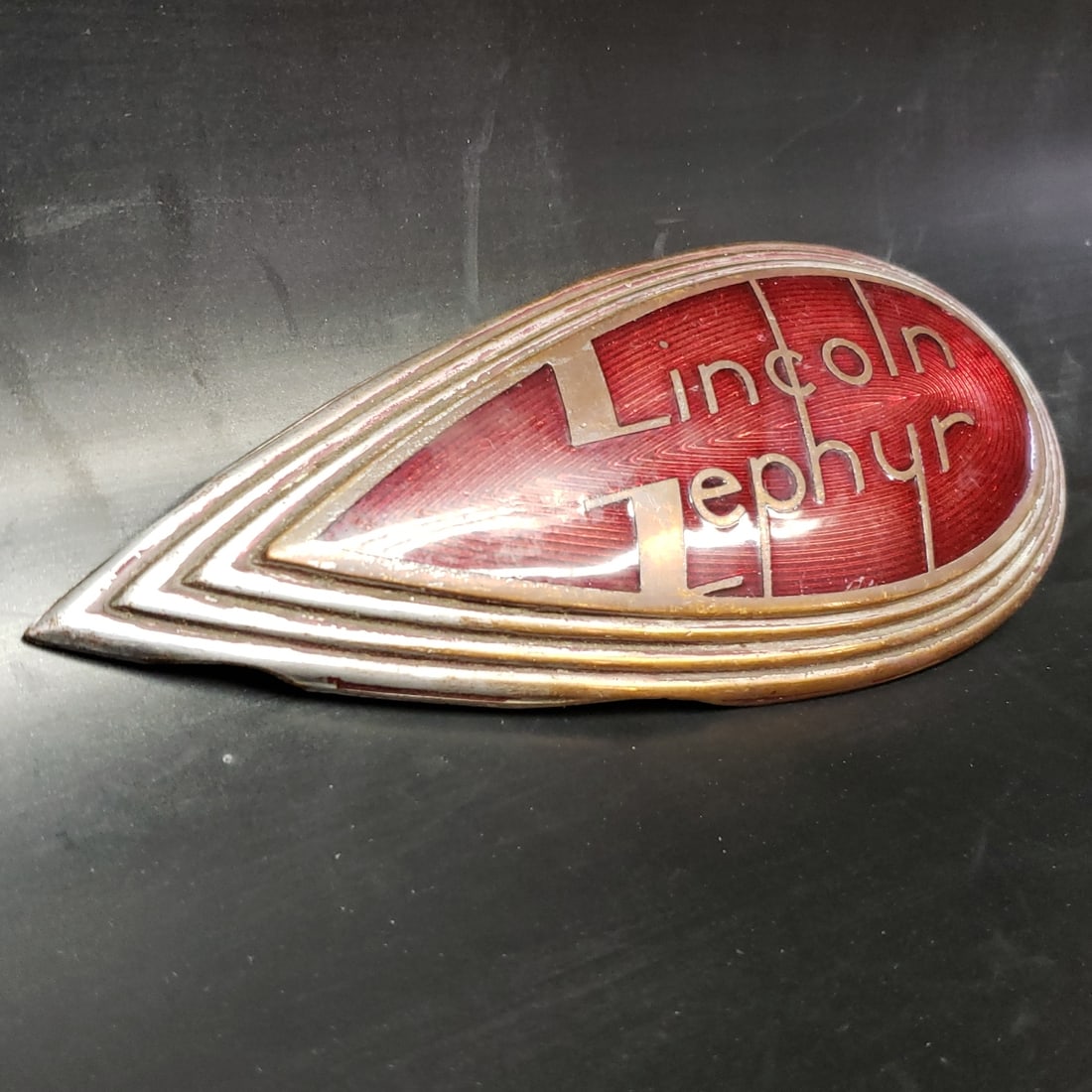 Original Lincoln Zephyr Side Plate: "Fresh to market from a lifetime collector. A nice selection of vintage tin and pressed steel along with die cast model and car related ephemera. All measurements are approximate.