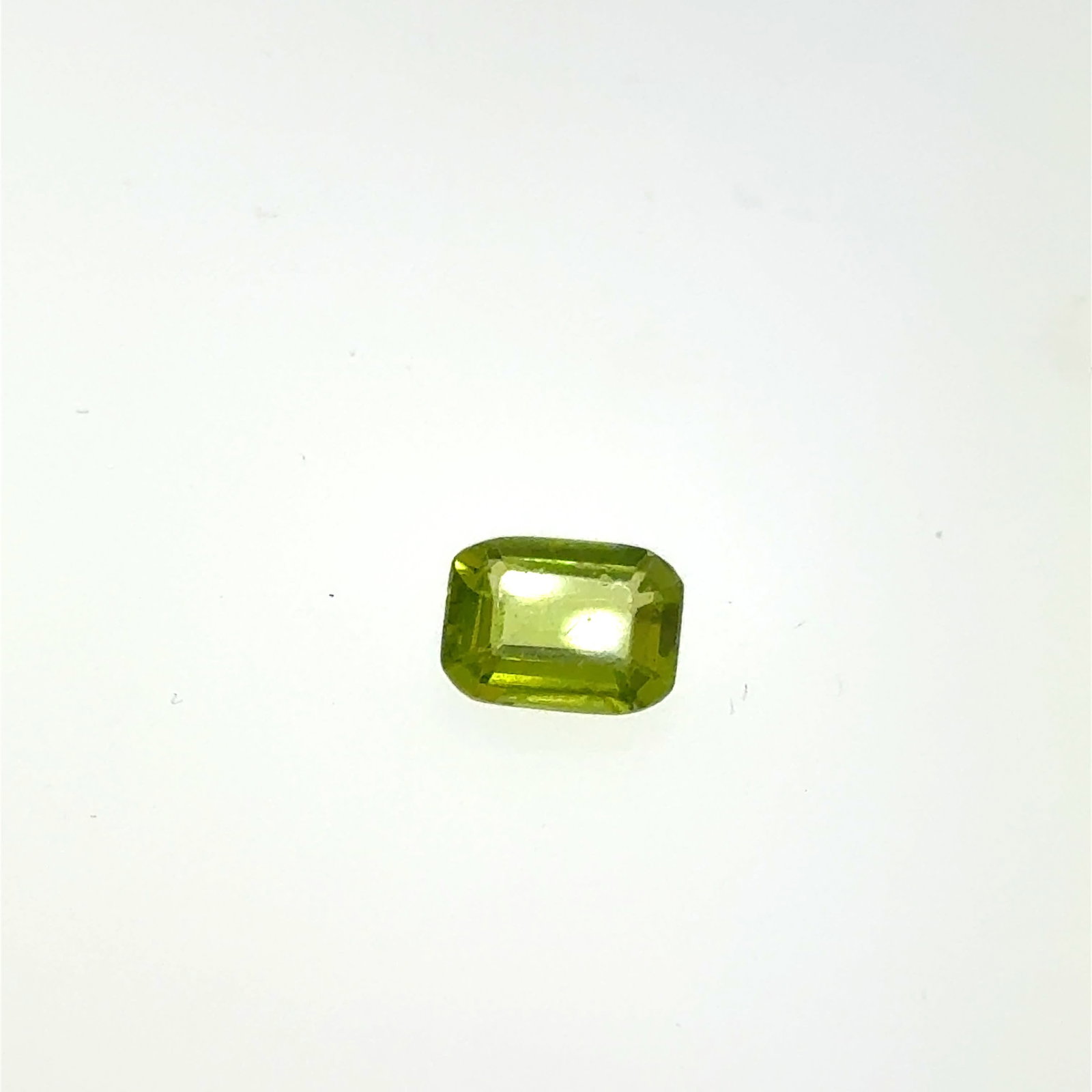 Emerald Cut Green Peridot Gemstone 1.5ct 5.9x8.2mm: This is a continuation of our pro jeweler's estate auction, but we've added some gems from another estate (JTV). The rest are from his personal collection, many faceted by himself. Gems were cataloged