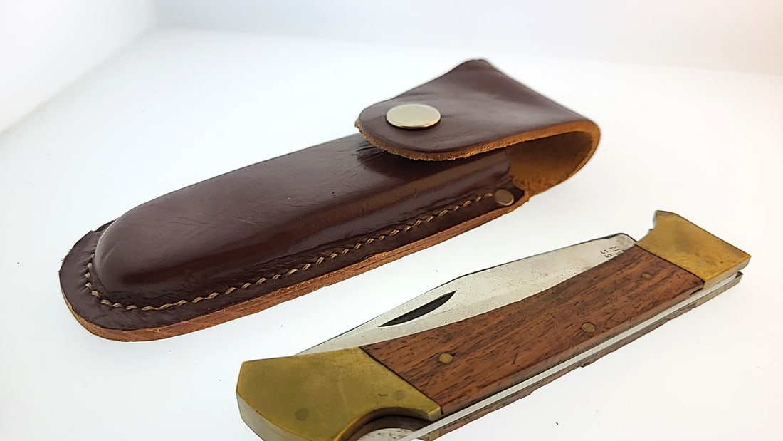 Folding Pocket Knife with Brown Leather Sheath, Wood & Brass Handle Pakistan: "great selection of pens, watches, knives, and other gift items. Pens are in as found condition, please inspect pictures closely. Watches are working unless stated otherwise, however they may need nee