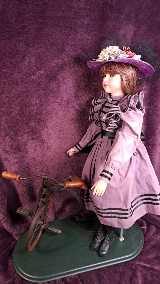Jan Mcclean Porcelain Victorian Lady Doll In Purple Dress With Floral Hat And Bicycle Display Base: Please read descriptions and examine pictures carefully. Take into account shipping when bidding. Loose support on base 36x25x15 10lbs Height: 25 Width: 15 Low Estimate: 25.00 High Estimate: 350.00