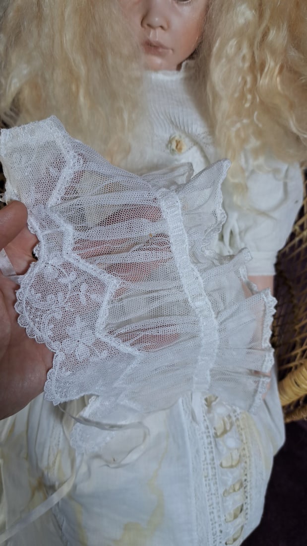 C Cumming Porcelain Doll with Blonde Hair, White Lace Dress, Bonnet and Wicker Chair - 12