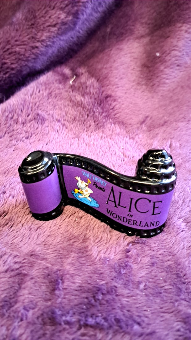 Walt Disney Classics Collection Alice In Wonderland Filmstrip Title Figurine With Box: 5 x 3 x 2 0. 5 lb Low Estimate: 10.00 High Estimate: 25.00