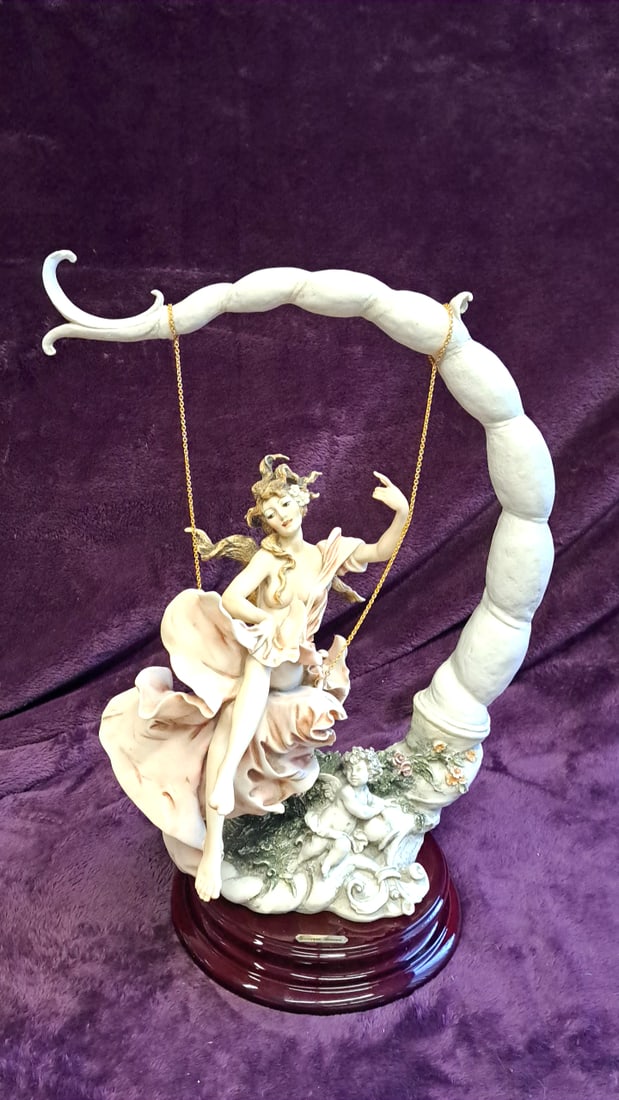 Giuseppe Armani Lady On Swing With Cherub Figurine Sculpture On Wood Base: 17 x 25 x 10 6 lb Low Estimate: 100.00 High Estimate: 275.00