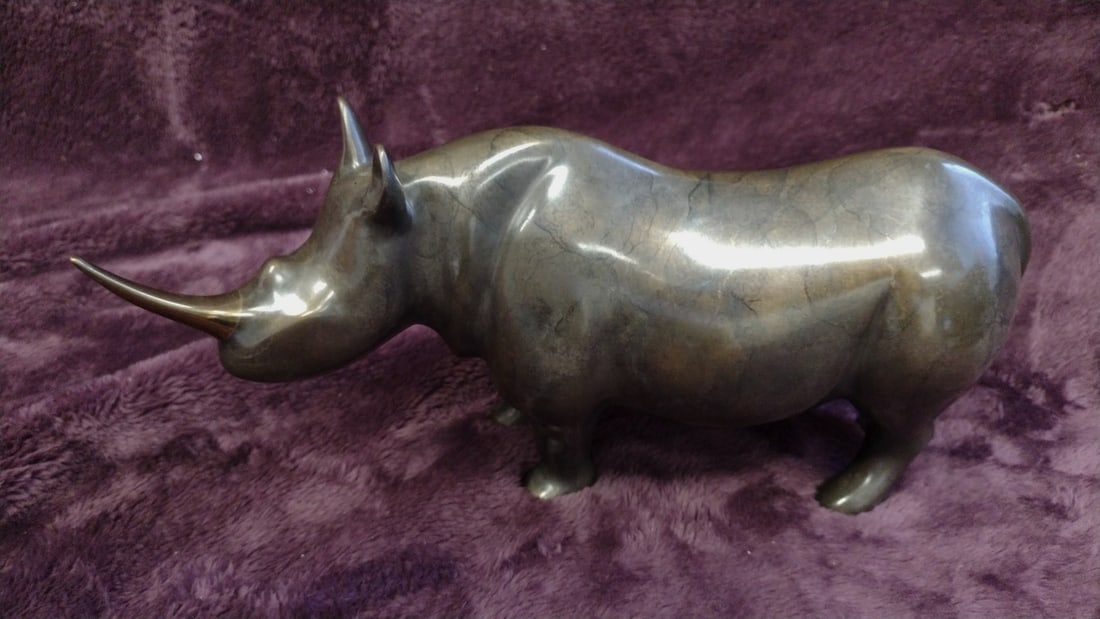 Loet Vanderveen Bronze Rhinoceros Figurine Sculpture, Approx. 10 In: 22 x 8 x 5. 5 5 lb Low Estimate: 50.00 High Estimate: 125.00