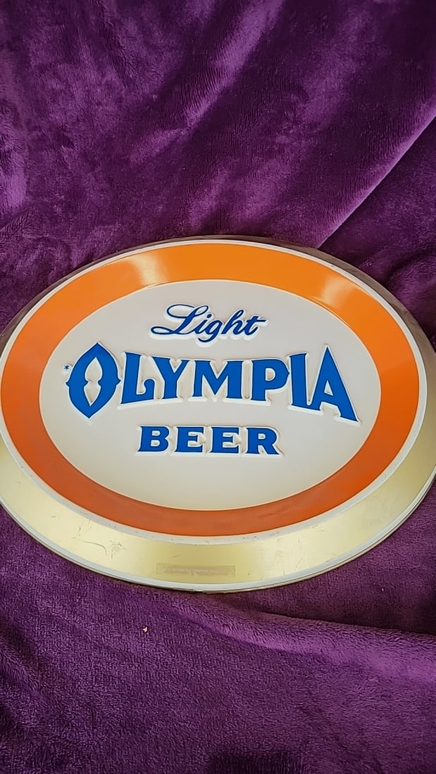 Olympia Light Beer Oval Plastic Wall Sign Orange Gold Trim: 15.5 x 11.5 x 1.5 1.2 lb Low Estimate: 25.00 High Estimate: 120.00