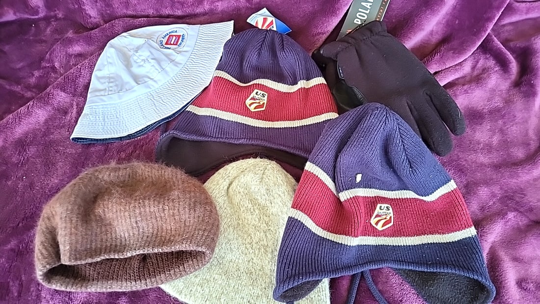 Winter Hat & Glove Lot: US Ski Team Beanies, Holland America Bucket Hat, Polartec Gloves: 10x10x10 2 Low Estimate: 15 High Estimate: 50