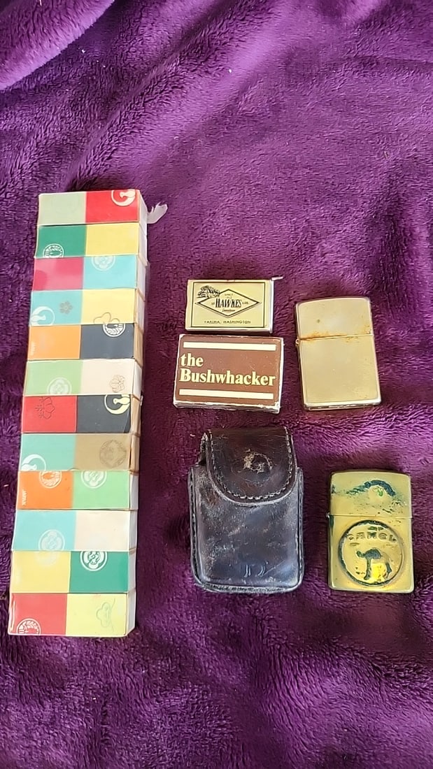Zippo Lighter Lot with Camel Logo Lighter, Hawkes Premium & The Bushwhacker Matchbooks: 6.5 x 9 x 1.5 1.2 lb Low Estimate: 15.00 High Estimate: 55.00