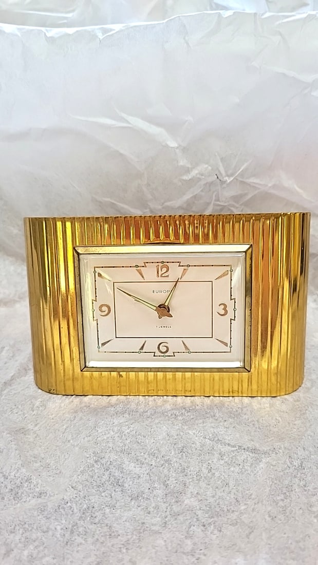 Europa 7 Jewels Brass Gold-Tone Mechanical Desk Clock with Ribbed Curved Case: Untested 5 x 5 x 3 1.5 lb Low Estimate: 15.00 High Estimate: 75.00