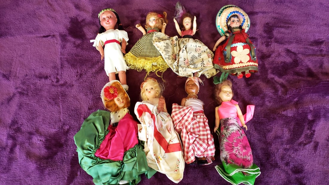 Lot of 8 International Souvenir Dolls in Traditional Dress, 7-13 in: 20 x 16 x 3 1.5 lb Low Estimate: 16.00 High Estimate: 60.00