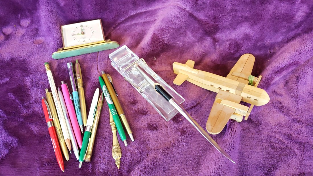 Europa 2 Jewels Desk Clock, Pens, Letter Opener & Wooden Airplane Model Lot: 12 x 8 x 4 2 lb Low Estimate: 15.00 High Estimate: 50.00