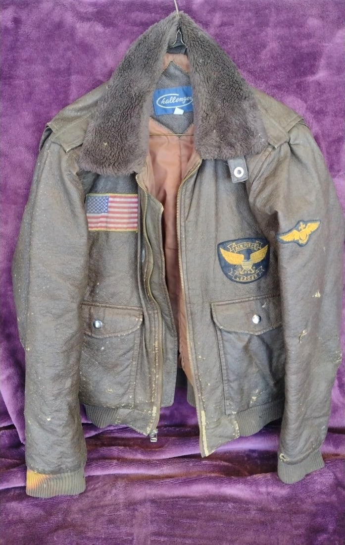 Challenger Brown Leather Bomber Jacket with Faux Fur Collar and Air Force Patches: Rips and rough condition 30 x 28 x 4 4.5 lb Low Estimate: 50.00 High Estimate: 120.00