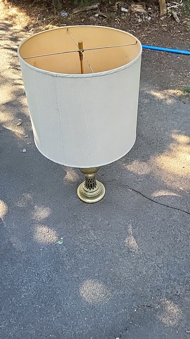 Ornate Brass Table Lamp With Cream Drum Shade And 3-light Socket: 22 inches to top of base. 34 inches to top of harp Low Estimate: 30.00 High Estimate: 180.00