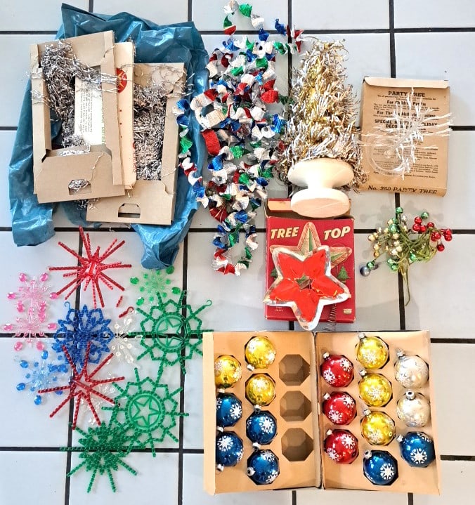 Vintage Christmas Ornament Lot, Plastic Bead Snowflakes, Balls, Tinsel, No. 250 Party Tree, Tree To: Some. Snowflakes are missing g spokes. The icicle. Strands are old. The ball ornaments are marked made in usa. 16 x 15 x 15in. 2lb Low Estimate: 12.00 High Estimate: 45.00