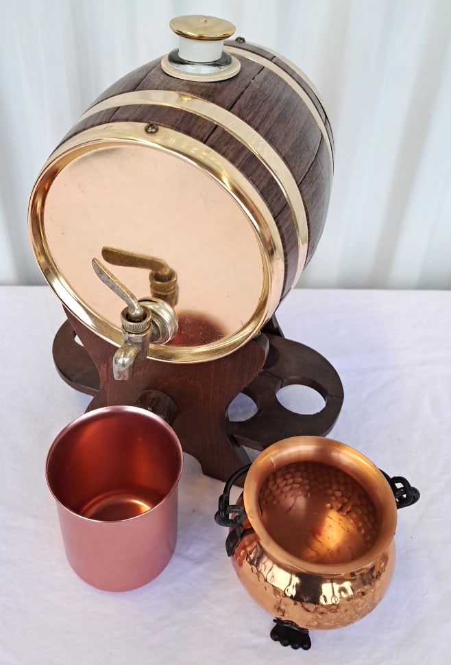 Barrel Beverage Dispenser Faux Wood And Bands, Copper Mug, Cauldron Cup: Spigot has some metal degradation. Wooden stand has a split. 9 x 9 x 7in 3lb Low Estimate: 10.00 High Estimate: 35.00