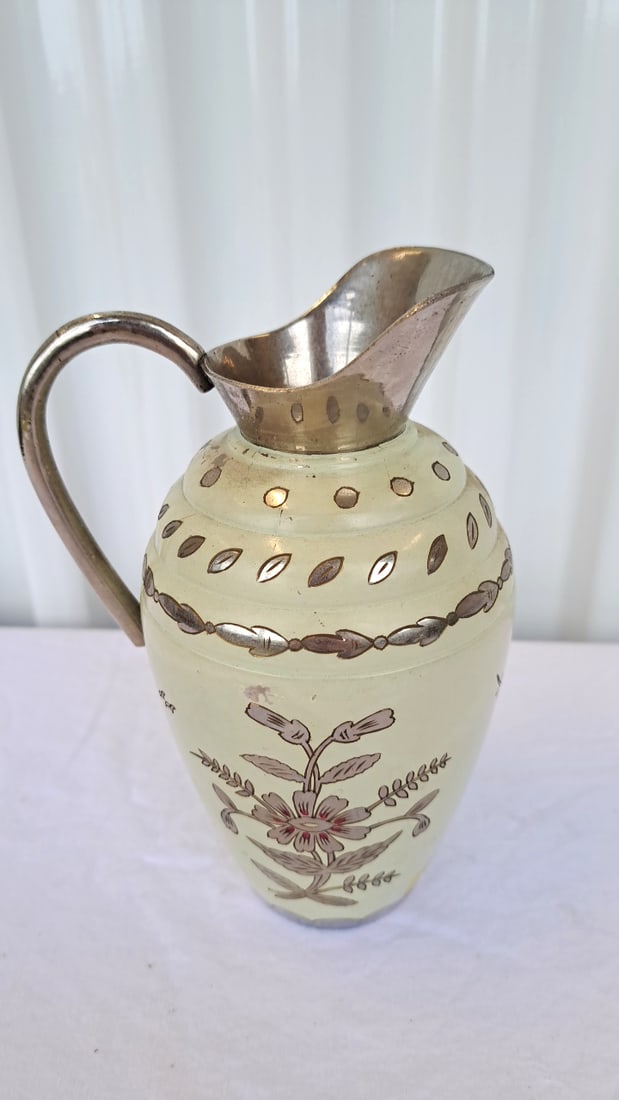 Indian Floral Decorative Pitcher With Silver-tone Handle, Spout And Trim: There are a few patches where the cream coat is missing. 7 x 5 x 4in. 2lb Low Estimate: 12.00 High Estimate: 45.00