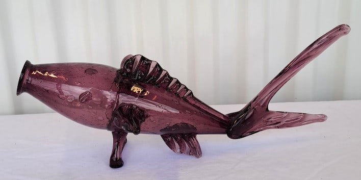 Amethyst Purple Blown Art Glass Fish Sculpture With Controlled Bubbles, 13 In: Good condition overall though mouth opening has little nibbles all around it. That might have been in the manufacture. Tiny colr mark inside - possibly paper. 13 x 7 x 6in. 2lb Low Estimate: 25.00