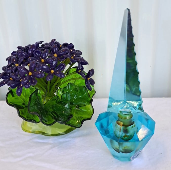 Irice Hand Cut Crystal Perfume Bottle With Faux Plastic Flower Bunch: Good condition. Can see one air bubble. Old perfume residue on stopper and in bottle. 8 x 7 x 7in. 1lb Low Estimate: 10.00 High Estimate: 35.00