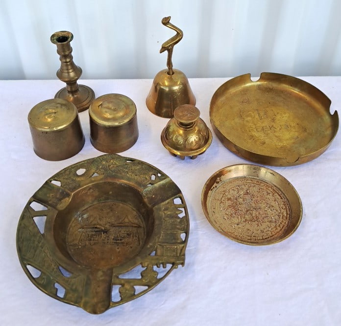Brass Decorative Lot With Ashtrays, Bell, Candlestick And Lidded Boxes: 6 x 6 x 4in. 2lb Low Estimate: 20.00 High Estimate: 50.00