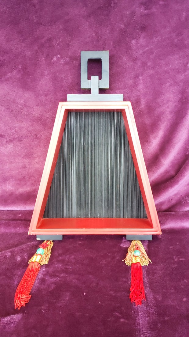 Red Lacquer Trapezoid Slat Frame With Tassels Read: Top handle cracked, see last 2 photos 16x22x4 3lb Low Estimate: 10.00 High Estimate: 40.00