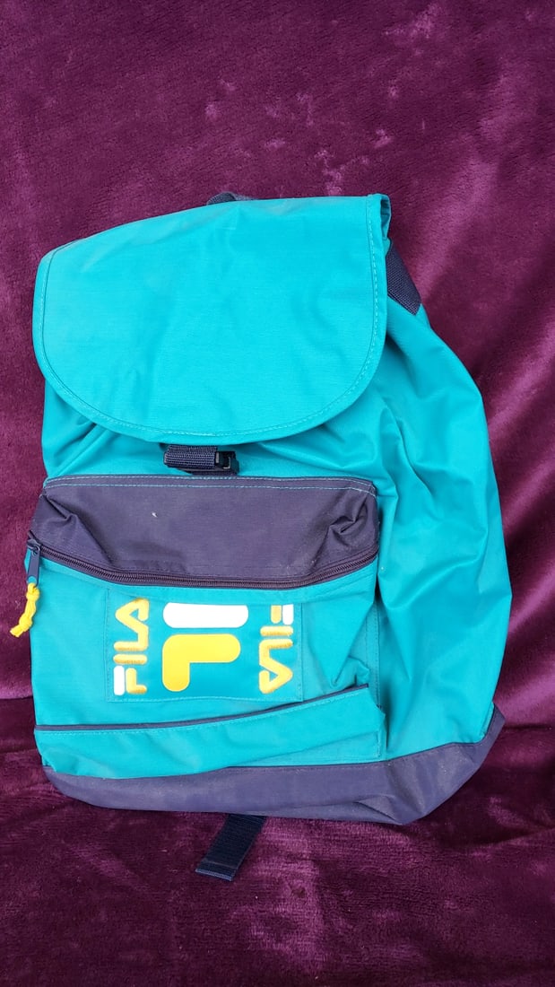 Vintage Fila Teal Navy Flap-top Drawstring Backpack With Front Zip Pocket: 13x16x6 1lb Low Estimate: 10.00 High Estimate: 40.00
