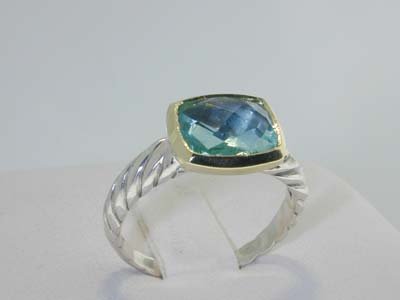 7: David Yurman Aquamarine Silver and 18k Y: The weight of the ring is 4.2 g. The size of the ring is 7. The size of the aquamarine is 11 x 9 mm.