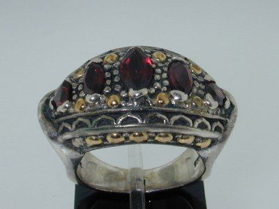 BJC18k Yellow Gold/Silver Garnet Ring.: BJC 18k Yellow Gold/Silver Garnet Ring. The total ring's weight is 14.0 grams. The measurement of the ring's face is 21x15 mm, Thickness: 7 mm. The sizes of the Garnet are 5x3 mm - 4x8 mm. The size of