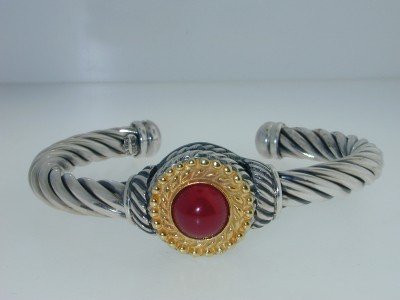 The Menegatti 18K Gold, Silver Carnelian: The Menegatti 18K Gold and Silver Carnelian Bangle The total bangle weight is 33.7 grams. The size of the Carnelian is 10 mm in diameter. The size of bangle : 63x47 mm, thickness: 7 mm.