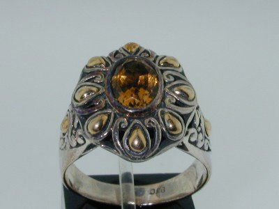 BJC Silver/18k Yellow Gold Citrine Ring.: BJC Silver/18k Yellow Gold Citrine Ring. The total ring's weight is 6.6 grams. The size of the citrine is 9x7 mm. The measurement of the ring's surface is 18x 16 mm and Thickness: 8 mm. The size o