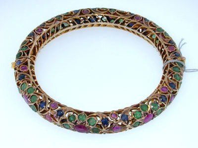 Antique 10K Gold Multi-Color Stone Bangle: Antique 10K Gold Multi-Color Stone Bangle from 1940. The total bangle weight is 37.1 grams. Multi-color Stone are: Emerald, Ruby, Sapphire The size of stone are from 3 to 5mm in diameter. The size of