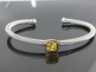 David Yurman 18k Yellow Gold/Silver Citrine B: David Yurman 18k Yellow Gold/Silver Citrine Bangle! Bangle's Weight : 16.8 grams. The size of Citrine is 7x7 mm. The measurements of the inside Bangle are 57 x 42 mm and the thickness is 4 mm. There i