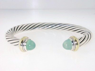 David Yurman Silver 14K Yellow Gold Chalcedony Ban: David Yurman Silver & 14K Yellow Gold Chalcedony Bangle.Bangle's Weight :31.8 grams.The size of Chalcedony : 8 x5 mm.The measurements of the Inside Bangle are 55 x 45 mm and the thickness is 7 mm.It i