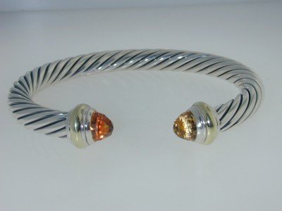 David Yurman Silver & 14K Gold Lemon Citrine Bangl: David Yurman Silver & 14K Yellow Gold Lemon Citrine Bangle. The total Bangle's weight is 40.3 grams. The size of Lemon Citrine: 7 mm. The measurement of the inside bangle is 60 x 43 mm, Thickness: 7 m