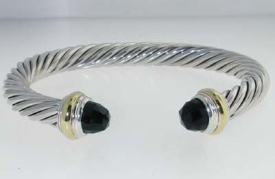 David Yurman 14k Yellow Gold/Silver Onyx Bangle: David Yurman 14k Yellow Gold/Silver Onyx Bangle. Bangle's Weight: 41.9 grams. The size of Onyx is 6 mm in diameter. The measurements of the Bangle are 58 x47 mm and the thickness is 7 mm. There is Sta
