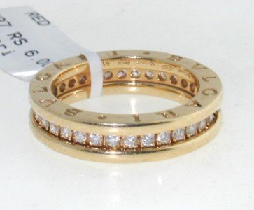 Bvlgari 18K Yellow Gold Diamond Ring: Authentic Bvlgari 18K Yellow Gold Diamond Ring.The total ring's weight is 7.5 grams.The diamonds weight are approximately 0.64 cts., G color and VVS clarity.The size of the ring is 6.There are stamp "