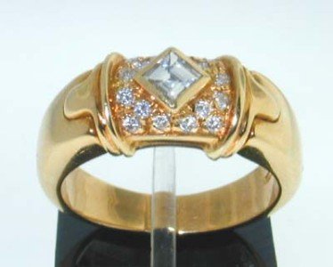 Bvlgari 18K Yellow Gold Diamond Ring.: This is a Bvlgari 18K Yellow Gold Diamond Ring. The total Ring's weight is 9.6 grams. Total weight of 16 round diamond aside: 20 pts, approximately G-H color, VS clarity. The weight of Princess cut di
