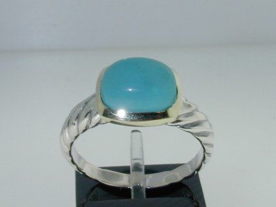 David Yurman 18k Yellow Gold/Silver Turquoise Ring: This is a Wonderful David Yurman 18k Yellow Gold/Silver Turquoise Ring. The total ring's weight is 4.1 grams. The size of the Turquoise is 10 x 7 mm. The size of the ring is 7.25 This is a wonderful r