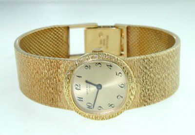 Patek Philippe 18K Yellow Gold Wrist Watch: Patek Philippe 18K Yellow Gold Wrist Watch The total watch's weight is 62.5 grams. The measurements of watch head is 20 x 20 mm and 6 mm thick. The length of watch: 6" swiss made Water Resistant Chain