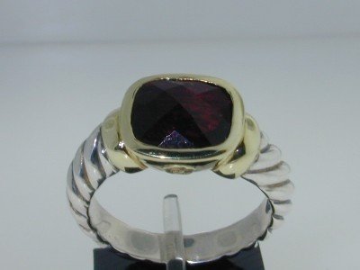 David Yurman Silver/14K Yellow Gold Garnet Ring: This is a Wonderful David Yurman Silver/14K Yellow Gold Garnet Ring! The total ring's weight is 8.4 grams. The width of the ring face is 12x10 mm. The size of the ring is 7.25. There is "D.Y 925 585" 