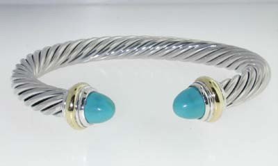 David Yurman 14k Yellow Gold/Silver Turquoise Bang: David Yurman 14k Yellow Gold/Silver Turquoise Bangle. Bangle's Weight: 41.4 grams. The size of Turquoise is 6 mm in diameter. The measurements of the Bangle are 58 x47 mm and the thickness is 7 mm. Th