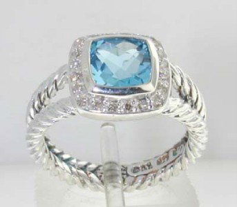 David Yurman Silver Blue Topaz & Diamond Ring.: David Yurman Silver Blue Topaz & Diamond Ring. The total ring's weight is 5.4 grams. The total weight of the diamond is 0.2 cts approximately, I color SI clarity. The size of the Blue Topaz is 7 x 7 m