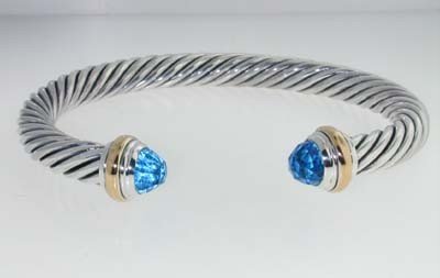 David Yurman Silver, 14K Gold & Blue Topaz Bangle!: David Yurman Silver, 14K Yellow Gold & Blue Topaz Bangle.Bangle's Weight : 38.9 grams.The size of Blue Topaz : 6 x 6 mm.The measurements of the Inside Bangle: 56 x 47 mm and the thickness is 7 mm.Ther