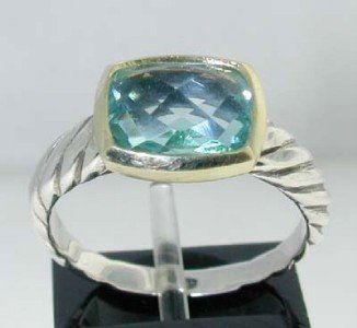 David Yurman 18k Gold/ Silver Blue Topaz Ring.: This is a Wonderful David Yurman 18k Gold/Silver Blue Topaz Ring. The total ring's weight is 4.1 grams. The size of the Blue Topaz is 10 x 8 mm. There is D.Y',925" 750"stamp on it. The size of the rin