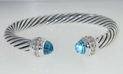 David Yurman Silver Blue Topaz & Diamond Bangle.: David Yurman Silver Blue Topaz & Diamond Bangle.The total Bangle's weight is 44.1 grams.The total diamond weight is 90 pts approxmiately, H-I color SI1 clarity.The size of Blue Topaz: 7 mm.The measure