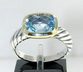 David Yurman 18k Gold/ Silver Blue Topaz Ring.: David Yurman 18k Gold/Silver Blue Topaz Ring.The total ring's weight is 5.8 grams.The size of the Blue Topaz is 10 x 8 mm.There is D.Y',925" 750"stamp on it.The size of the ring is 7"