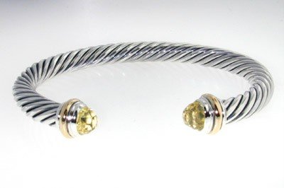 David Yurman Silver,14K Gold, Lemon Citrine Bangle: David Yurman Silver, 14K Yellow Gold, Lemon Citrine Bangle.The total Bangle's weight is 38.9 grams.The size of Lemon Citrine: 7 mm.The measurement of the inside bangle is 58 x 48 mm, Thickness: 6 mm.