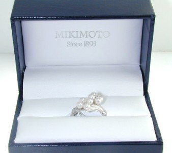 Mikimoto 18K White Gold Pearl Diamond Ring.: Mikimoto 18K White Gold pearl Diamond Ring The total ring weight is 3.6 grams The Total weight of Diamond is 0.04 pts. approximately . H color VS clarity. There are total 8 pearls on ring, Size: 3 mm,