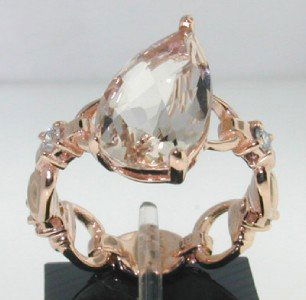 Gucci 18K Rose Gold, Champagne Topaz & Diamond Rin: Gucci 18K Rose Gold, Champagne Topaz & Diamond Ring. The total ring's weight is 5.4 grams. The total weight of diamond: 0.16 cts. G-H color VVS clarity The size of champagne Topaz: 14 x 7 mm The size