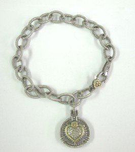 Judith Ripka 18K Yellow Gold/Silver, Diamond Brace: Judith Ripka 18K Yellow Gold/ Silver & Diamond Bracelet. The total bracelet's weight is 22 grams. The total diamond weight: 0.26 cts. I color, SI clarity The bracelet is 6.5" long.