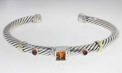David Yurman 14k Yellow Gold/Silver Multi-Stone Bangle: David Yurman 14k Yellow Gold/Silver Multi-Stone Bangle! Bangle's Weight : 29.4 grams. Multi-Stone are citrine, Garnet. The measurements of the inside Bangle are 53 x 46 mm and the thickness is 5 mm.